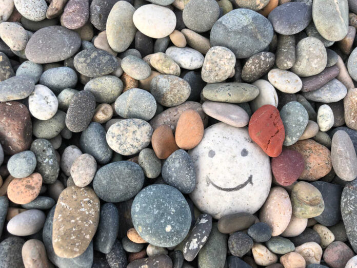 Stone,With,A,Painted,Smile.,On,The,Shore,,One,Stone