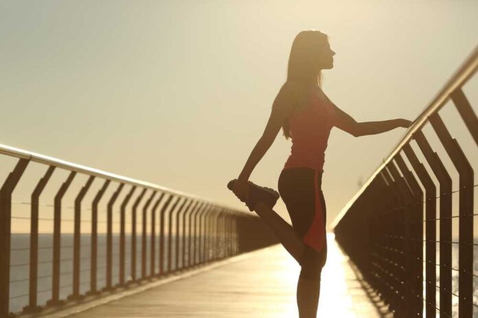 Runner,Silhouette,Doing,Stretching,Exercises,At,Sunset,In,A,Bridge