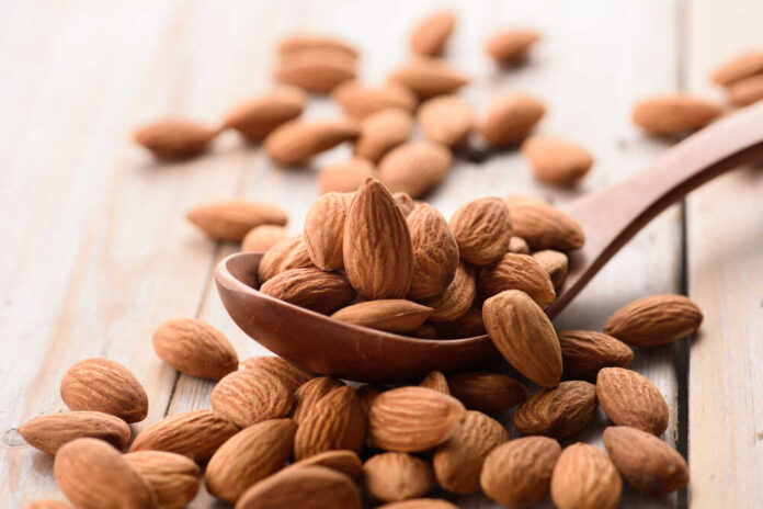 Almonds,Pour,From,Wood,Spoon