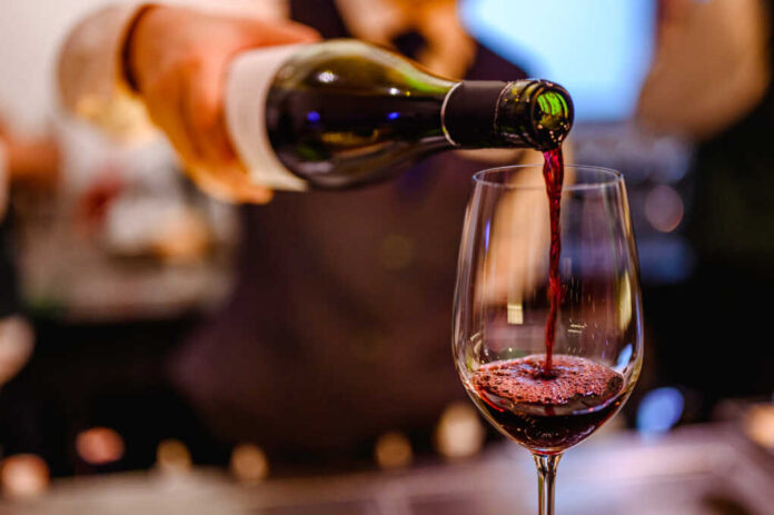 Pouring,Glass,Of,Red,Wine,From,A,Bottle.