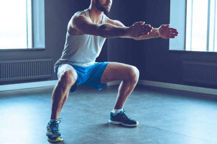 Deep,Squat.,Part,Of,Young,Man,In,Sportswear,Doing,Squat