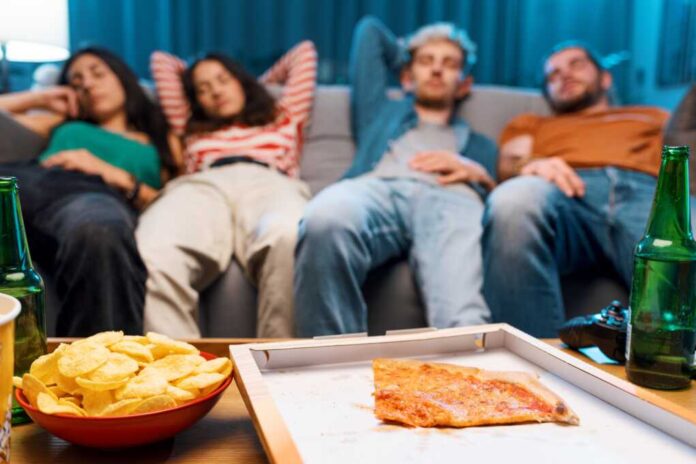 Lazy,Friends,Napping,On,The,Couch,After,Eating,Pizza,Together