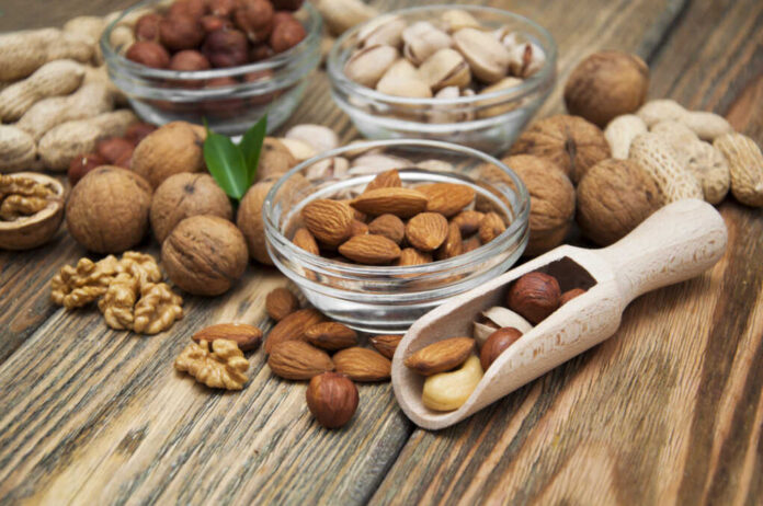 Mixed,Nuts,In,Glass,Bowls,On,A,Wooden,Background