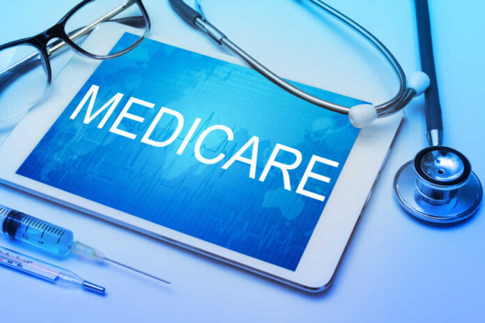 Medicare,Word,On,Tablet,Screen,With,Medical,Equipment,On,Background